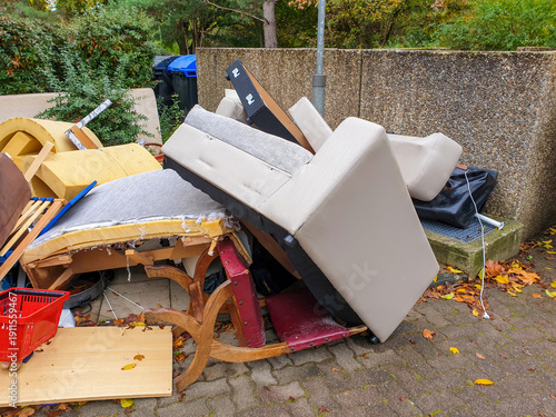 Bulky waste, garbage, unnecessary furniture, big trash on streets of Germany (Sperrmüll). Pile large sized household garbage prepared for removal, recycling. 