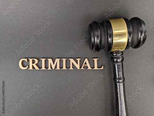 Black judge’s gavel beside bold “CRIMINAL” text symbolizes legal authority, justice, and criminal law enforcement