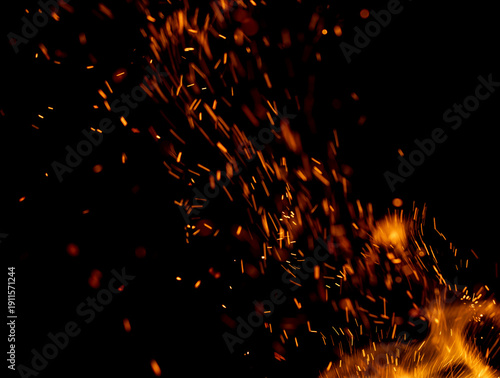 A black background with a lot of orange sparks