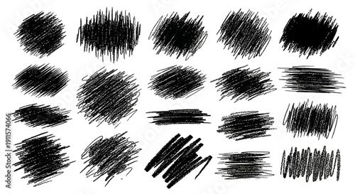 Collection of black brush strokes in various shapes and sizes on a clean background viewed from directly above