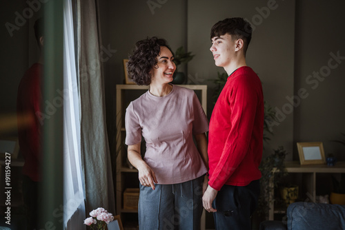 Obraz na plátne Mother and teenage son smiling and bonding at home