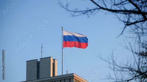 Russian flag waving on government building with clear blue sky