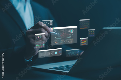 Analyst manages the system database, AI analysis data plans, and reports. shows a dashboard chart on the computer. research on digital platform technology. ai analytics business concept
