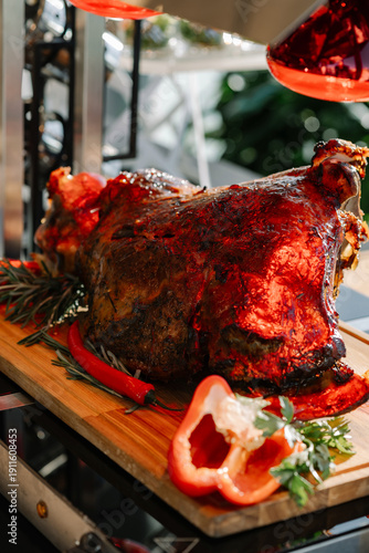 Roasted Whole Leg of Meat on Carving Board with Heat Lamps