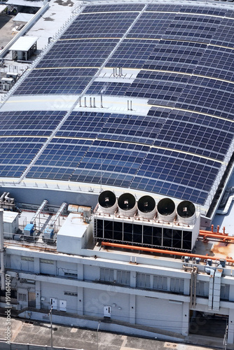 Cooling towers in data center building. Air conditioning cooling towers in front of building with fins to the front. Industrial cooling towers or air cooled water chillers with piping system.