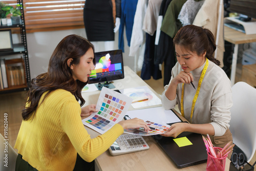 Cuadro en lienzo Fashion stylists collaborating on color palette for apparel design