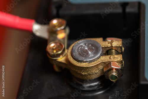 Battery positive pole, cable connected to car battery, closeup