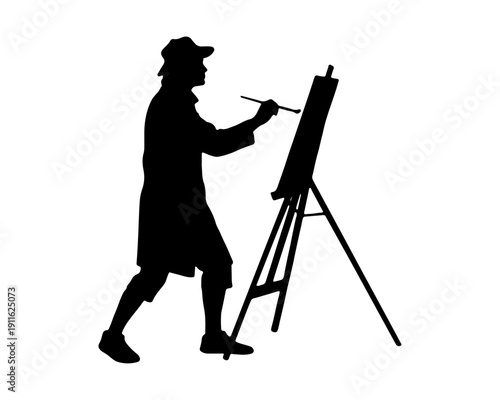 Black silhouette of an artist standing and painting on an easel