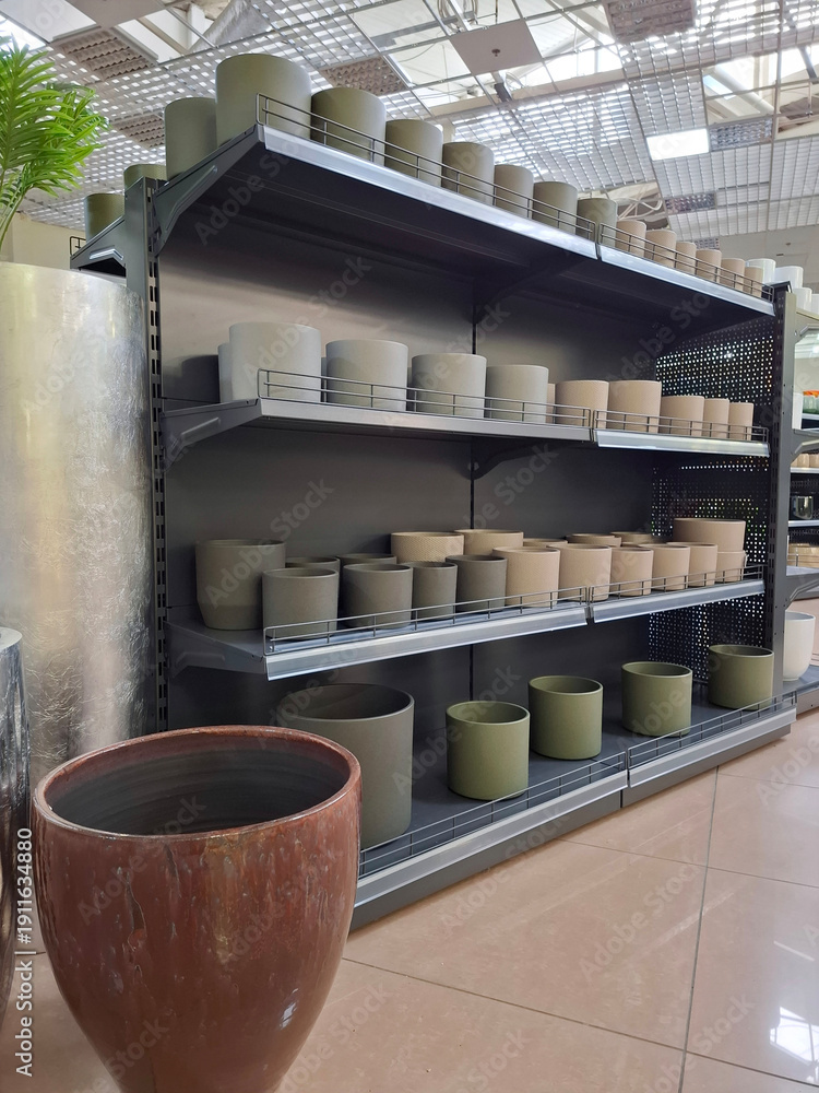 Fototapeta premium Ceramic flower pots on supermarket shelves. Ceramic products in flower shop