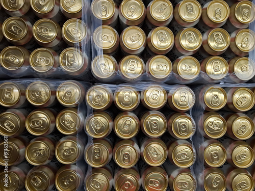Many golden beer cans in crates, top view