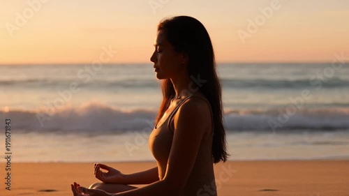 Woman meditating on serene beach at golden sunrise with soft warm lighting for wellness and mindfulness