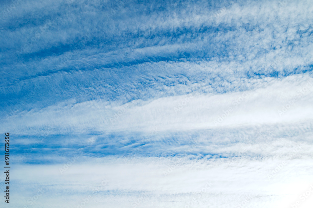 Obraz premium Evening blue sky landscape, cumulus clouds in the blue sky lit by soft evening sunlight
