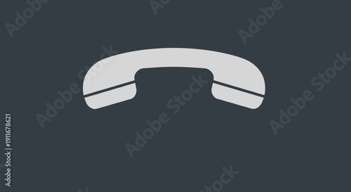 White Telephone Handset on Dark Background.