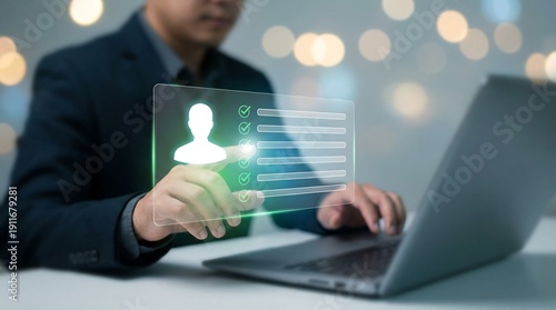 A man is thoughtfully interacting with a glowing virtual personal profile and checklist interface displayed over his laptop, suggesting online registration, identity verification, or task management.