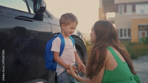 Back to school. Mom meets her son at school. Child mother family concept. Mom brings her boy son back to lifestyle school. Mom returns her son to. school. education concept.