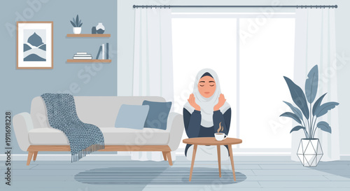 Young Muslim woman in hijab relaxing at home with coffee