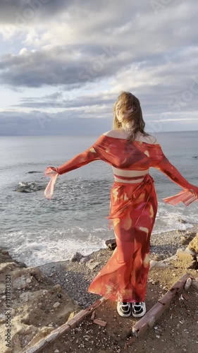 young woman in red dress on the beach