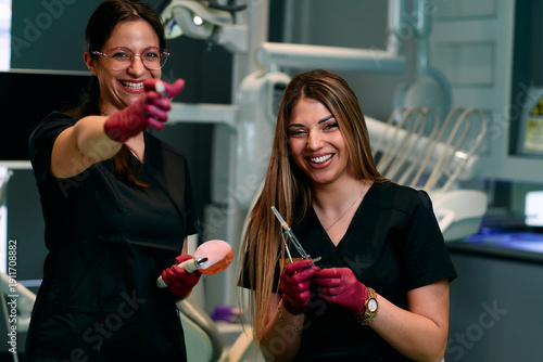 Two Friendly Dental Assistants Share a Laugh While Preparing Tools in Modern Clinic