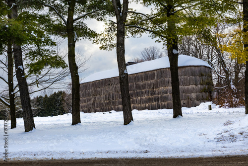 Iroquoian village in winter. A longhouse in a reconstructed 15th-century village. Milton, Crawford Lake, Ontario, Canada.