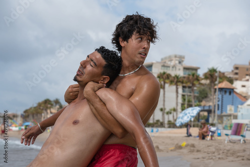 Canvas Print Lifeguard rescuing a drowning man on beach