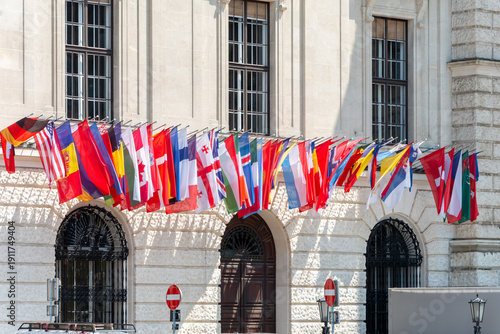 Photography Row of national country flags at entrance of administrative building, architecture and diplomatic symbolism of Europe
