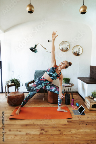 Woman practicing yoga at home