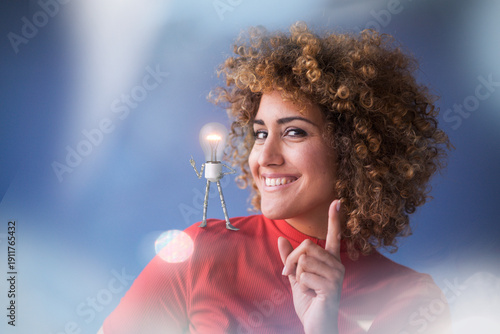 Portrait of smart woman with lightbulb on her shoulder