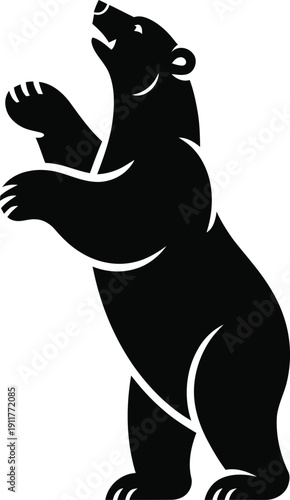 A black bear standing on its hind legs with paws raised up