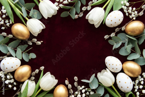 Frame from golden eggs, white tulips on red background. Greeting banner for spring Easter day, a Christian holiday with copy space.