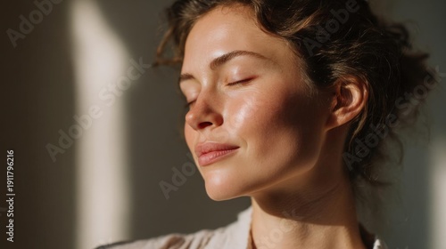 Close-up portrait of a young woman with her eyes closed and her head tilted slightly to the side.