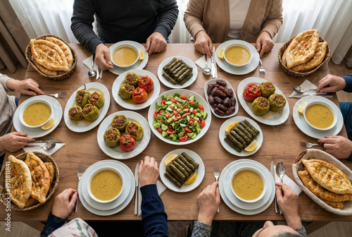Top down flat lay view of a traditional Turkish dinner table with stuffed peppers grape leaves soup and dates for iftar