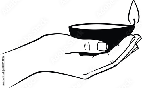 A hand holding a small candle with a lit flame in a candle holder