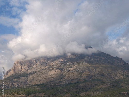 Φωτογραφία Breathtaking aerial perspective of rugged limestone slopes beneath billowing clo