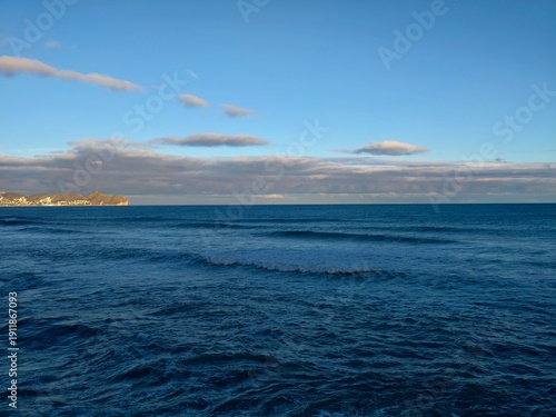 Obraz na plátně Waves crash under cloudy skies, Vigorous winds propel tumbling water against dis