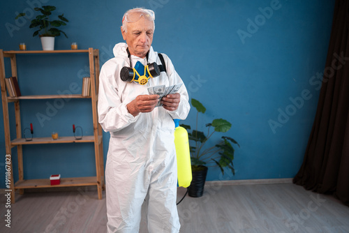 Cuadro en lienzo Senior male disinfection worker counting money cash dollars at home interior