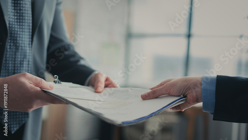 Business people are exchanging document