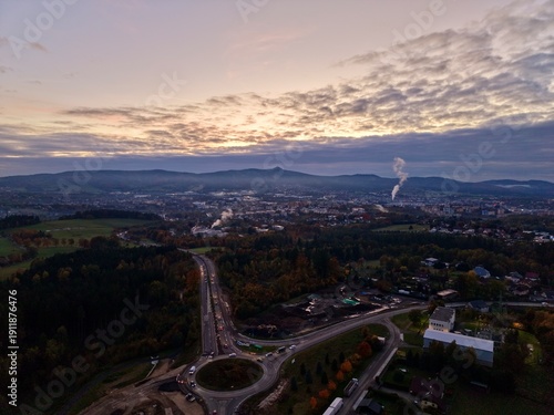 Konstfotografi aerial view of evening city junction featuring converging roads and distant indu