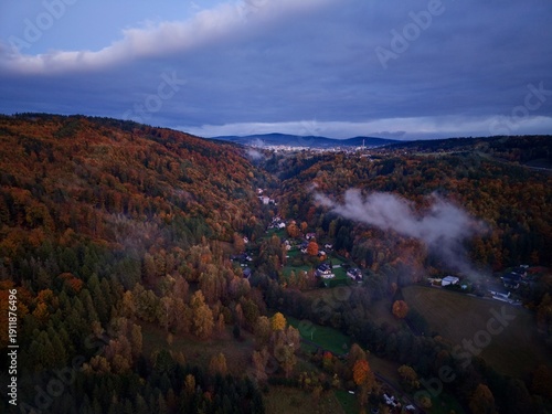 фотографія quiet village beneath misty hills, idyllic hamlet nestled under cloudcovered for