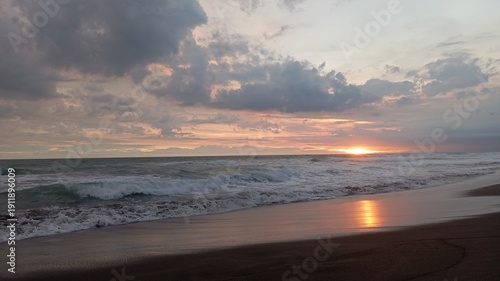 Natural coastal sunset panorama with reflective shoreline and dramatic sky, perfect for stock footage, relaxation media, cinematic intro sequences.