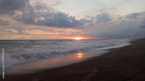 Scenic beach horizon with vibrant evening clouds and ocean motion, useful for mindfulness apps, travel documentaries, promotional materials.