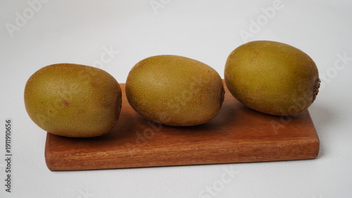 Golden kiwi or also known as yellow kiwi, has a softer texture and a sweeter, less bitter taste compared to green kiwi isolated on a white background.