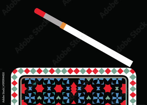A lit cigarette resting on an ornate box with a geometric pattern against a black background