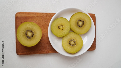 Golden kiwi or also known as yellow kiwi, has a softer texture and a sweeter, less bitter taste compared to green kiwi isolated on a white background.