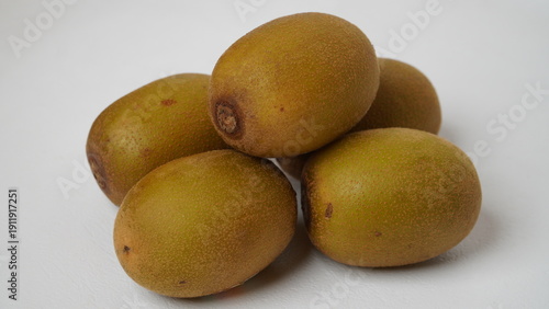 Golden kiwi or also known as yellow kiwi, has a softer texture and a sweeter, less bitter taste compared to green kiwi isolated on a white background.