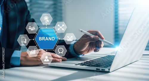 Person working on laptop with brand strategy icons displayed