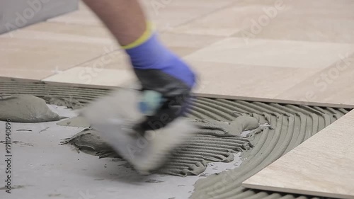 Close Up of Worker Installing Ceramic Floor Tiles