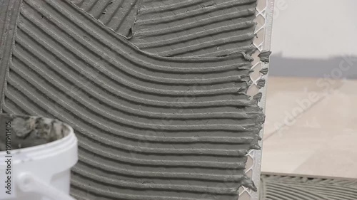 Close Up of Worker Installing Ceramic Floor Tiles