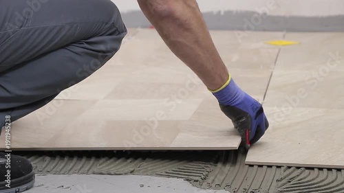 Close Up of Worker Installing Ceramic Floor Tiles
