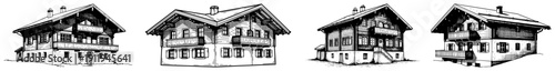 Set of traditional alpine chalets with wooden balconies in mountain architectural style
