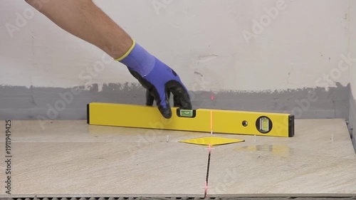 Close Up of Worker Installing Ceramic Floor Tiles